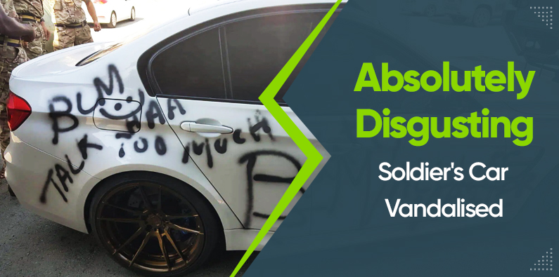 im1_gi_n A white car with black graffiti and offensive words spray-painted on the side. Text overlay reads Absolutely Disgusting Soldiers Car Vandalised. Brown alloy wheels are visible.